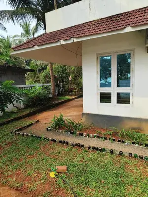 a house with a garden in front of it at Raaga on the Beach in Kannur