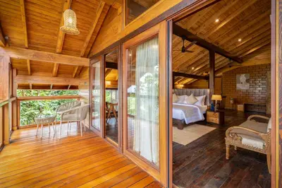 a room with a bedroom and a bed in a house at amã Stays and Trails The Malabar Villa Hibiscus, Kozhikode in Puthuppādi