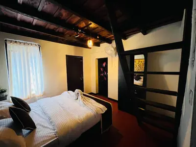 a bedroom with a large bed and a window at Paroommel Haven Wayanad in Kenichira