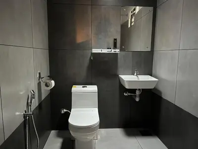 a bathroom with a toilet and a sink at Paroommel Haven Wayanad in Kenichira