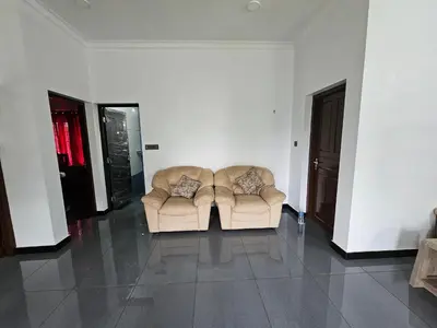 two chairs in a living room with white walls at MATHER RAJAGIRI FURNISHED APARTMENTS in Alwaye