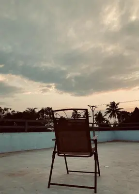 a chair sitting on top of a roof at MATHER RAJAGIRI FURNISHED APARTMENTS in Alwaye