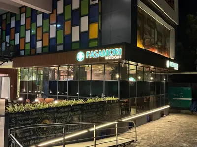 a fast food restaurant with a sign in front of it at Palcastle Regency in Palakkad