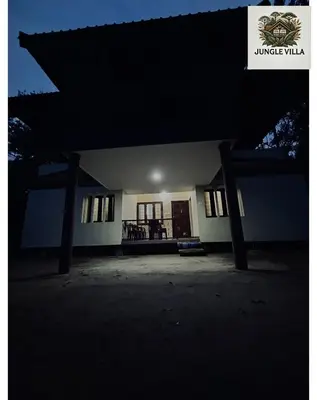 a view of a building at night at 4 Bedroom Jungle Villa in Panamaram