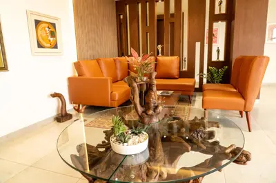 a living room with a glass table with plants on it at HOTEL ACHYUT in Tiruppūr