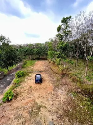 a car parked in the middle of a dirt road at Green Horizon, Luxury & Nature at Kothamangalam in Kotamangalam