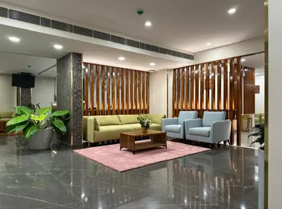 a lobby with couches and chairs and a table at The Habitat Suites-Walkable distance to Guruvayoor temple in Guruvāyūr
