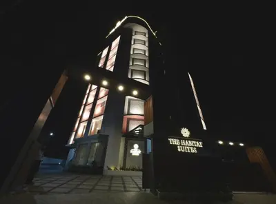 a building with a lit up tower at night at The Habitat Suites-Walkable distance to Guruvayoor temple in Guruvāyūr