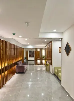 a lobby with a couch and chairs in a building at The Habitat Suites-Walkable distance to Guruvayoor temple in Guruvāyūr