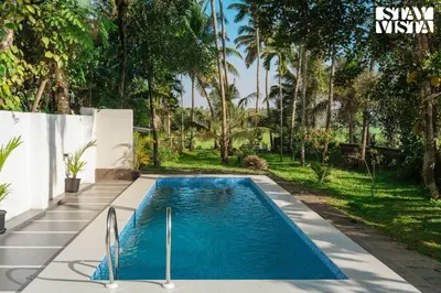a swimming pool in the backyard of a house at StayVista at Nature Nook with Pvt Pool & Terrace Access in Trichūr