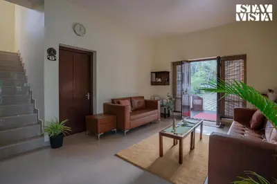 a living room with a couch and a coffee table at StayVista at Nature Nook with Pvt Pool & Terrace Access in Trichūr