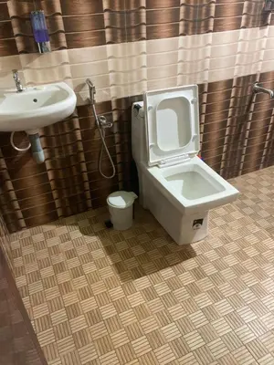 a bathroom with a toilet and a sink at MO’s Agro in Pāppinisseri