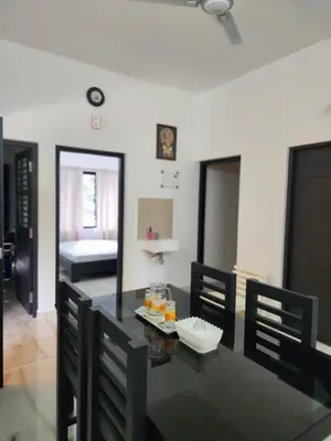 a dining room with a black table and chairs at Olive Homestay 1bhk Diamond Ernakulam in Alwaye