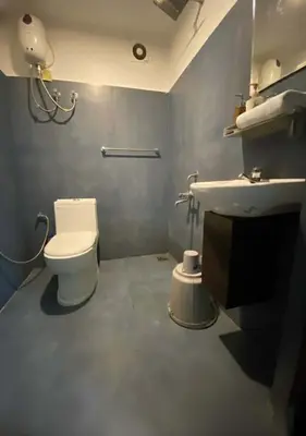a bathroom with a toilet and a sink at Joys Stay in Trichūr