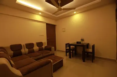 a living room with a couch and a table at VVP serviceapartments cochin Airport in Nedumbassery