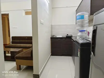 a small kitchen with a sink and a refrigerator at VVP serviceapartments cochin Airport in Nedumbassery
