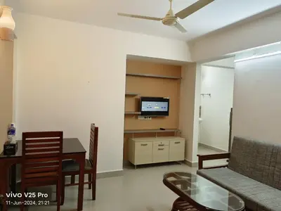 a living room with a couch and a table and a tv at VVP serviceapartments cochin Airport in Nedumbassery