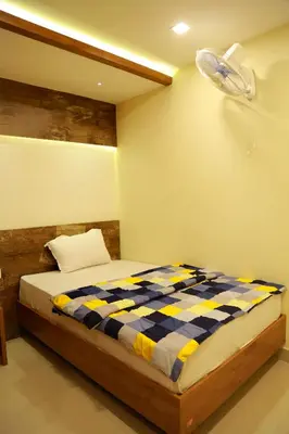 a bedroom with a bed and a fan at Kaira Regency in Olakara