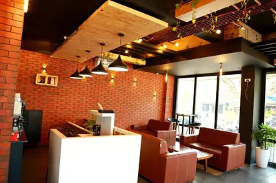 a restaurant with chairs and a brick wall at Kaira Regency in Olakara