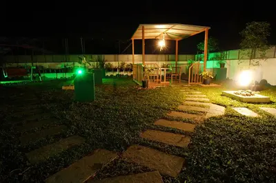 a garden at night with a tent and a playground at UNIVERSAL RESIDENCY in Perumbavoor