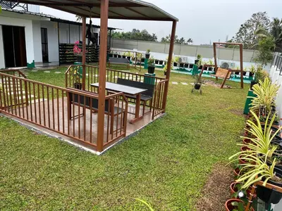 a picnic table and a gazebo in a yard at UNIVERSAL RESIDENCY in Perumbavoor