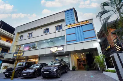 a building with three cars parked in front of it at UNIVERSAL RESIDENCY in Perumbavoor