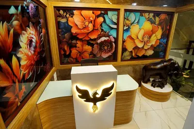 a room with a statue of a cow and paintings at UNIVERSAL RESIDENCY in Perumbavoor
