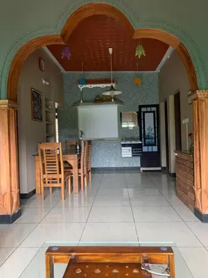 a kitchen and dining room with a table and chairs at Maskan Home Stay in Kakkadampoyil
