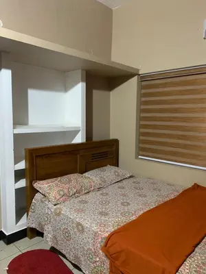 a bedroom with a bed and a window at Maskan Home Stay in Kakkadampoyil