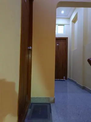 an empty hallway with a door and a hallway sidx sidx at Royal Comforts in Mysore