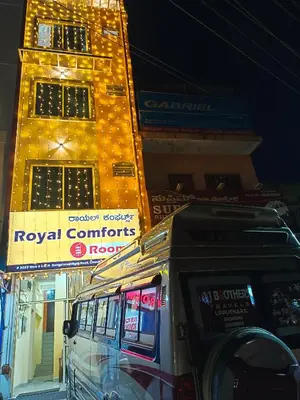 a van parked in front of a building at night at Royal Comforts in Mysore