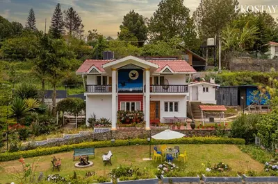 a house with a garden in front of it at EKOSTAY - Moonlight Villa in Kodaikānāl