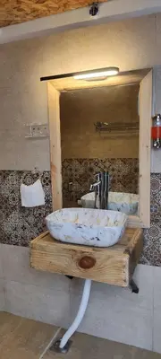 a sink in a bathroom with a mirror at Divercity Luxury Glamp in Kodaikānāl