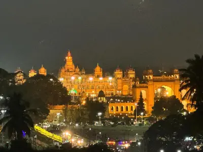 a large building with lights in front of it at night at S K Legacy Hotel in Mysore