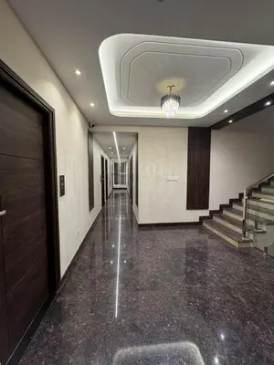 a hallway of a building with stairs and a chandelier at S K Legacy Hotel in Mysore