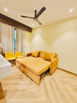 a bedroom with a bed and a ceiling fan at S K Legacy Hotel in Mysore