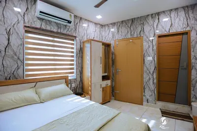 a bedroom with a bed and a stone wall at AN REGENCY in Edappāl