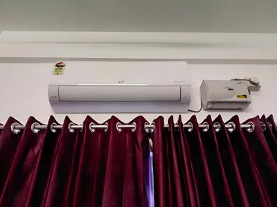 a row of red curtains and a printer on a wall at Spacious 2BHK Near Airport in Cochin