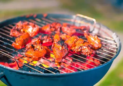 a bunch of food cooking on a grill at Kodai Outdoor Valley in Kodaikānāl