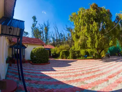a brick driveway in front of a house at LA Address Retreat - The Heritage Homestay in Ooty