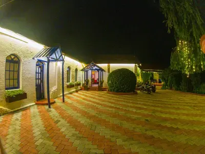 a house with a brick courtyard at night at LA Address Retreat - The Heritage Homestay in Ooty