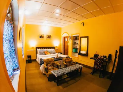 a living room with a bed and a couch at LA Address Retreat - The Heritage Homestay in Ooty