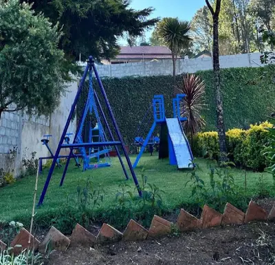 a yard with a playground with a blue slide at LA Address Retreat - The Heritage Homestay in Ooty