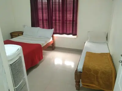 a small room with two beds and a window at Samz estate stay 2BHK in Madikeri