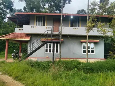 a house with a staircase in front of it at Samz estate stay 2BHK in Madikeri
