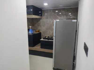 a kitchen with a white refrigerator in a room at Woodside Haven in Chekadi