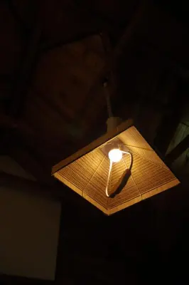 a light that is hanging from a ceiling at Royal Wooden villa in Mananthavady