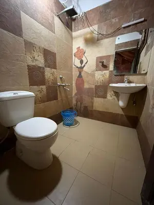a bathroom with a toilet and a sink at Royal Wooden villa in Mananthavady