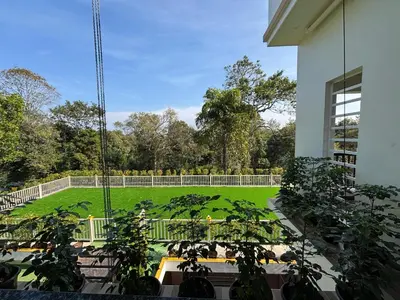 a view of a garden from a building at Coorg Le Embera in Virajpet