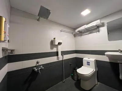 a bathroom with a toilet and a sink at Happy Villa Homestay in Chelakara